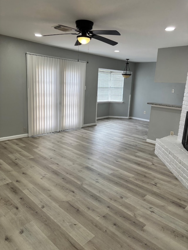 815 Pebbleshire Dr, Houston, TX 77062 - unfurnished living room with baseboards, ceiling fan, recessed lighting, wood finished floors, and a brick fireplace