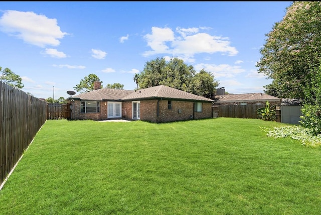 815 Pebbleshire Dr, Houston, TX 77062 - rear view of property featuring french doors, brick siding, and a chimney