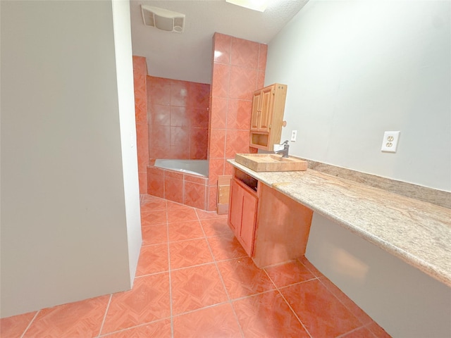 403 Fern Ln, Wharton, TX 77488 - full bath featuring tile patterned floors, a relaxing tiled tub, and vanity