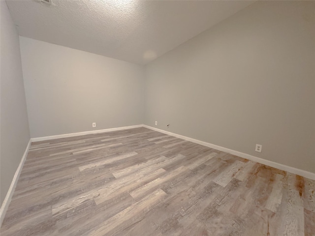 403 Fern Ln, Wharton, TX 77488 - empty room featuring wood finished floors, baseboards, and a textured ceiling