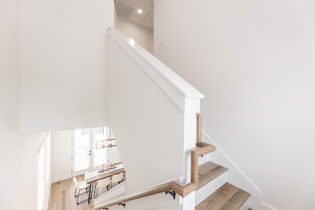 1613 Erin St, Houston, TX 77009 - staircase with wood finished floors and a chandelier