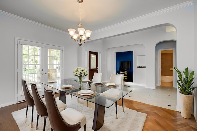6410 Drayton Hall, Missouri City, TX 77459 - dining space featuring ornamental molding, french doors, a chandelier, arched walkways, and baseboards