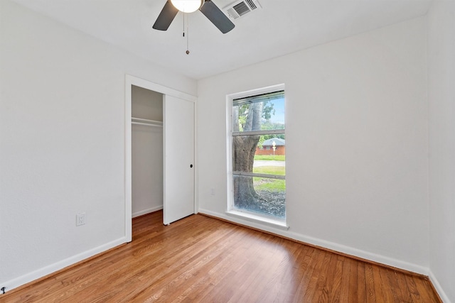 2635 Dragonwick Dr, Houston, TX 77045 - unfurnished bedroom featuring light wood-style floors, baseboards, a closet, and a ceiling fan