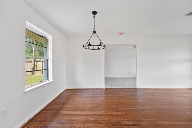 2635 Dragonwick Dr, Houston, TX 77045 - empty room featuring a chandelier, baseboards, and wood finished floors