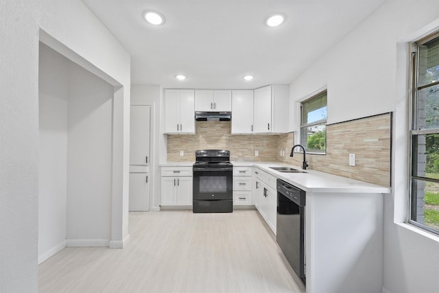 2635 Dragonwick Dr, Houston, TX 77045 - kitchen with black appliances, a sink, decorative backsplash, under cabinet range hood, and white cabinetry