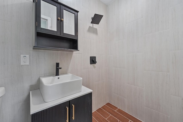 2635 Dragonwick Dr, Houston, TX 77045 - bathroom featuring vanity, wood tiled floors, toilet, and tiled shower
