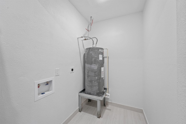 2635 Dragonwick Dr, Houston, TX 77045 - laundry room with hookup for an electric dryer, washer hookup, baseboards, and water heater