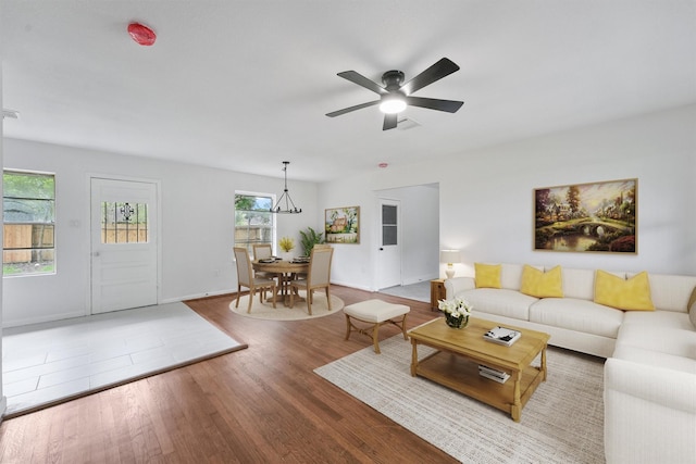 2635 Dragonwick Dr, Houston, TX 77045 - living area with wood finished floors, ceiling fan, and baseboards