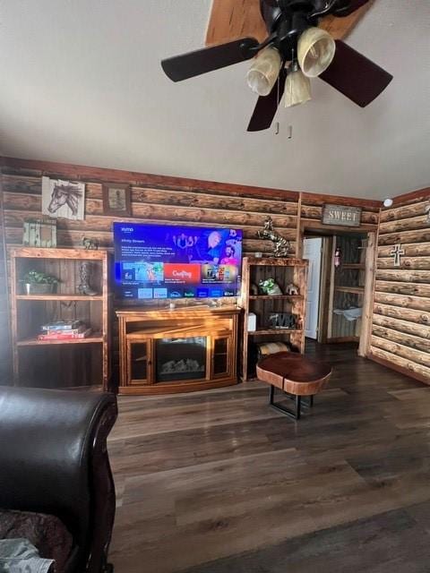 327 3rd St, Dickinson, TX 77539 - living room featuring log walls, wood finished floors, and ceiling fan