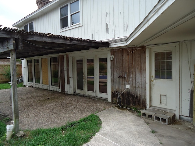 3823 Kiamesha Dr, Missouri City, TX 77459 - doorway to property featuring a chimney, a patio, a pergola, and metal roof