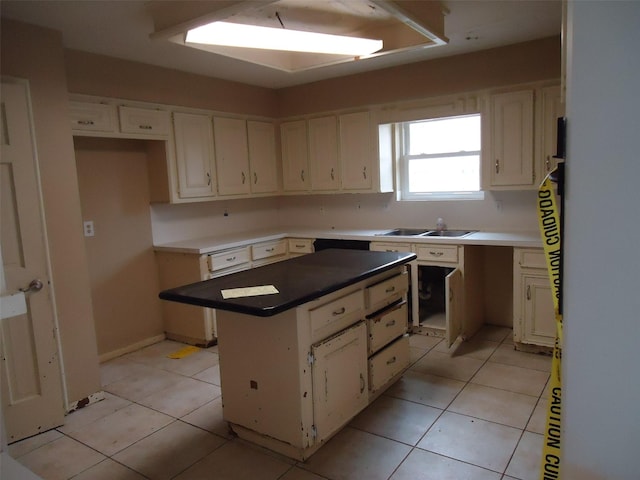 3823 Kiamesha Dr, Missouri City, TX 77459 - kitchen with a kitchen island, white cabinets, a sink, and light tile patterned floors