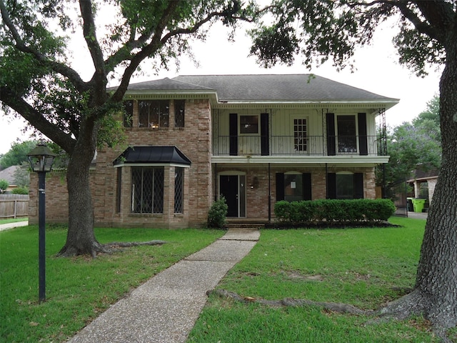 3823 Kiamesha Dr, Missouri City, TX 77459 - view of front of home with a balcony, brick siding, and a shingled roof