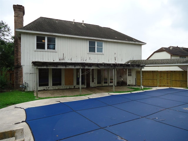 3823 Kiamesha Dr, Missouri City, TX 77459 - back of house with a chimney, a patio area, and roof with shingles