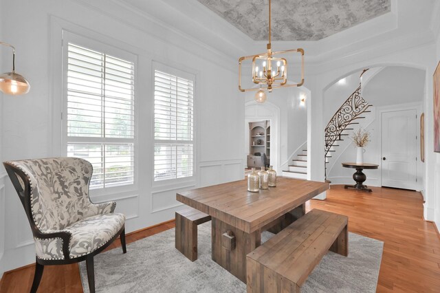 28310 Whispering Maple Way, Spring, TX 77386 - dining room with arched walkways, stairs, a chandelier, light wood-style floors, and a tray ceiling