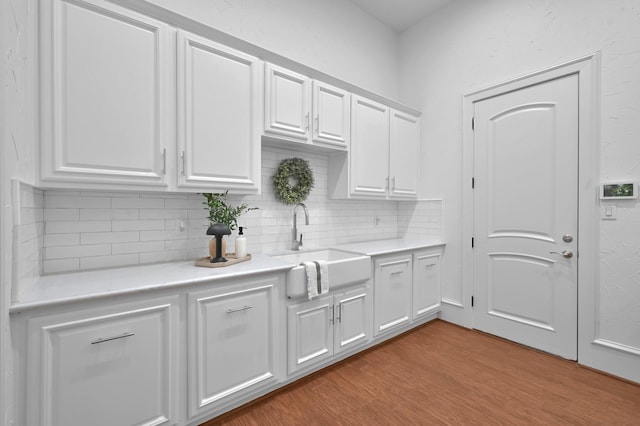 28310 Whispering Maple Way, Spring, TX 77386 - kitchen with white cabinets, light countertops, wood finished floors, and a sink