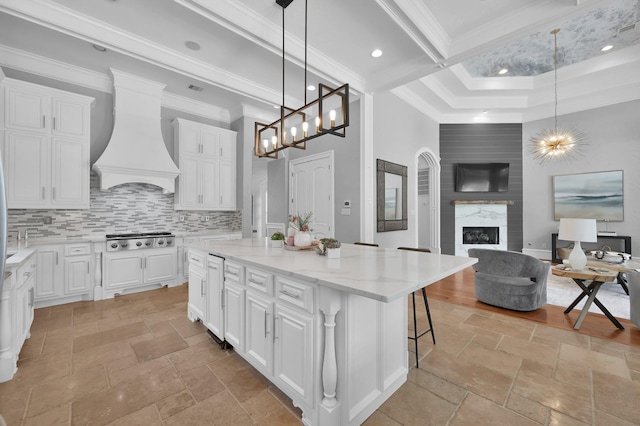 28310 Whispering Maple Way, Spring, TX 77386 - kitchen featuring stone tile floors, a chandelier, open floor plan, ornamental molding, and a towering ceiling