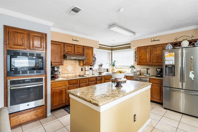 15110 Farndale Dr, Houston, TX 77062 - kitchen featuring black appliances, brown cabinets, under cabinet range hood, crown molding, and a textured ceiling