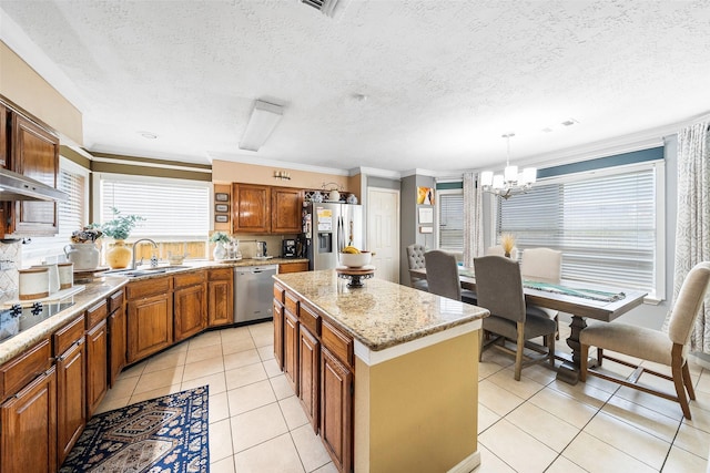 15110 Farndale Dr, Houston, TX 77062 - kitchen featuring appliances with stainless steel finishes, brown cabinets, a chandelier, a center island, and light tile patterned flooring