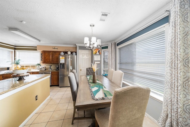 15110 Farndale Dr, Houston, TX 77062 - dining space featuring a chandelier, light tile patterned floors, a textured ceiling, crown molding, and baseboards