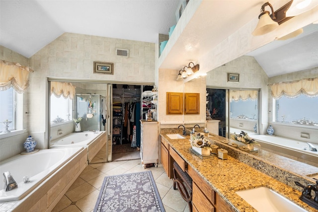 15110 Farndale Dr, Houston, TX 77062 - bathroom with vaulted ceiling, a tub with jets, double vanity, tile patterned flooring, and a walk in closet