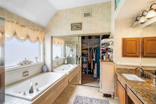 15110 Farndale Dr, Houston, TX 77062 - full bathroom featuring vaulted ceiling, tile patterned flooring, a walk in closet, a whirlpool tub, and a shower stall