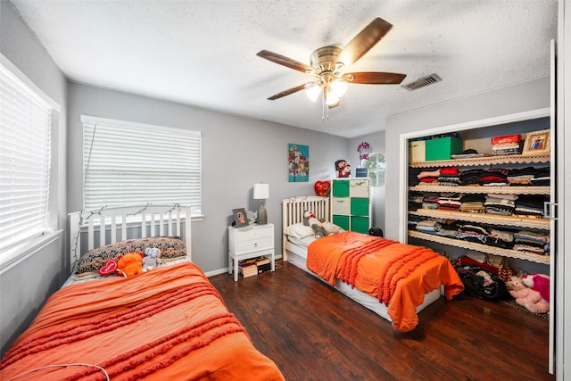 15110 Farndale Dr, Houston, TX 77062 - bedroom featuring wood finished floors, multiple windows, a ceiling fan, and a textured ceiling