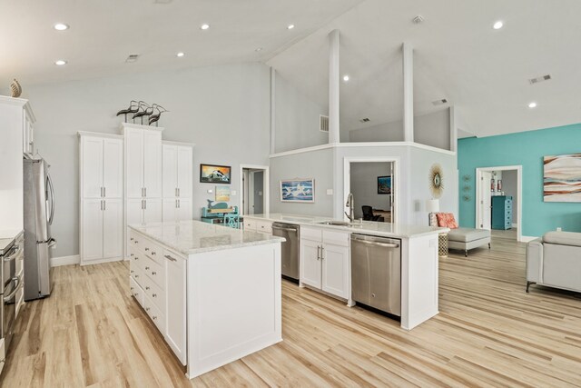 209 Anchor Ranch Rd, Trinidad, TX 75163 - kitchen featuring appliances with stainless steel finishes, a center island with sink, a sink, light wood-style floors, and white cabinetry