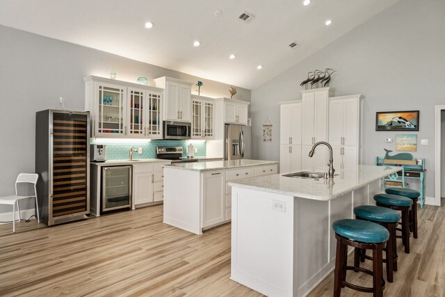 209 Anchor Ranch Rd, Trinidad, TX 75163 - kitchen with a sink, a kitchen island with sink, stainless steel appliances, wine cooler, and recessed lighting