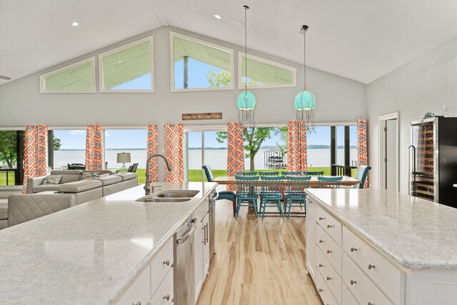 209 Anchor Ranch Rd, Trinidad, TX 75163 - kitchen with light wood-style floors, a sink, white cabinets, high vaulted ceiling, and light stone countertops
