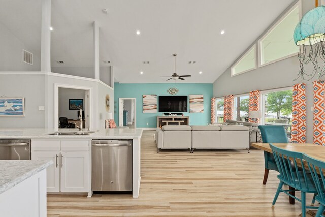 209 Anchor Ranch Rd, Trinidad, TX 75163 - kitchen with stainless steel dishwasher, high vaulted ceiling, white cabinetry, light wood finished floors, and recessed lighting