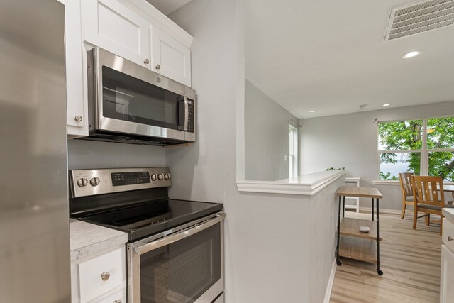 209 Anchor Ranch Rd, Trinidad, TX 75163 - kitchen featuring stainless steel appliances, plenty of natural light, white cabinetry, light wood-style floors, and recessed lighting