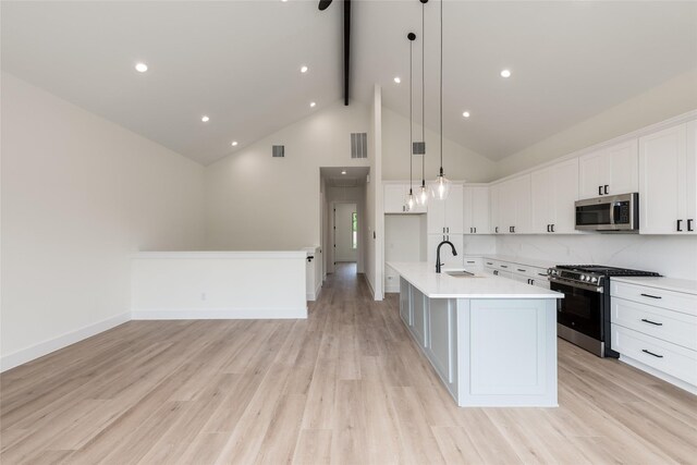 6137 Pacific Forest Dr, Houston, TX 77346 - kitchen with appliances with stainless steel finishes, beamed ceiling, a sink, light countertops, and white cabinetry