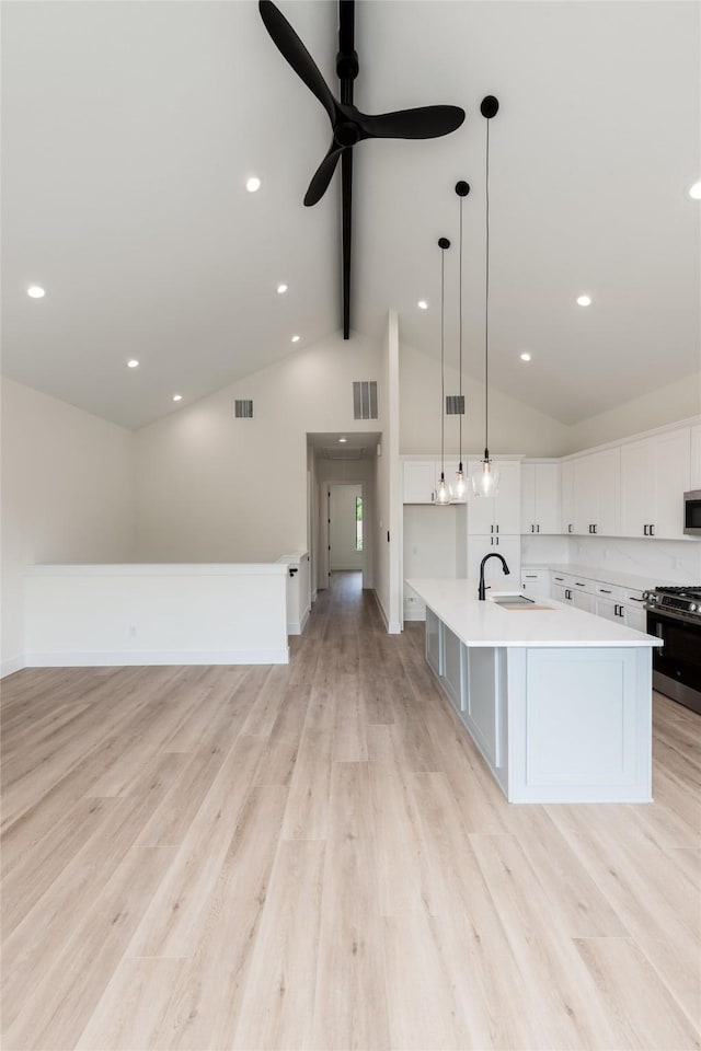 6137 Pacific Forest Dr, Houston, TX 77346 - kitchen featuring stainless steel appliances, beamed ceiling, light countertops, a ceiling fan, and white cabinets