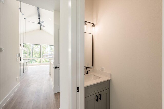 6137 Pacific Forest Dr, Houston, TX 77346 - bathroom with lofted ceiling, vanity, wood finished floors, and baseboards