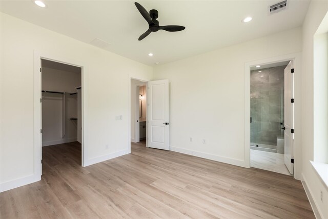 6137 Pacific Forest Dr, Houston, TX 77346 - unfurnished bedroom with recessed lighting, a spacious closet, light wood-type flooring, ensuite bath, and baseboards