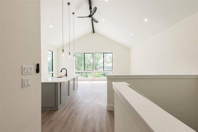 6137 Pacific Forest Dr, Houston, TX 77346 - hallway featuring beamed ceiling, light wood finished floors, a sink, high vaulted ceiling, and recessed lighting