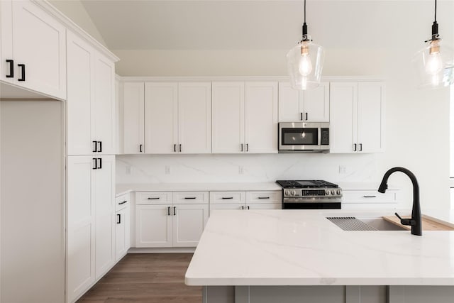 6137 Pacific Forest Dr, Houston, TX 77346 - kitchen with appliances with stainless steel finishes, a sink, decorative backsplash, white cabinets, and wood finished floors