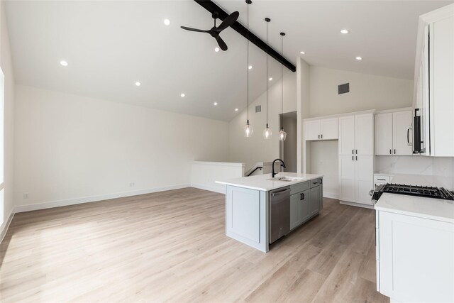 6137 Pacific Forest Dr, Houston, TX 77346 - kitchen with stainless steel appliances, a sink, a kitchen island with sink, open floor plan, and hanging light fixtures
