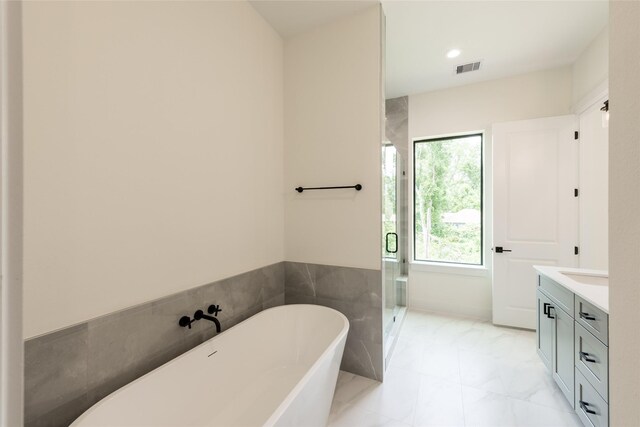 6137 Pacific Forest Dr, Houston, TX 77346 - full bathroom with a stall shower, a freestanding bath, marble finish flooring, and vanity