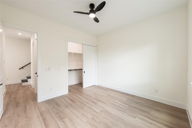 6137 Pacific Forest Dr, Houston, TX 77346 - unfurnished bedroom with light wood finished floors, baseboards, a closet, and a ceiling fan