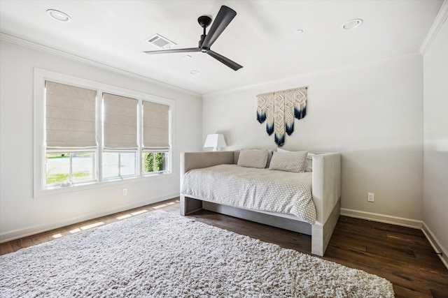 bedroom featuring crown molding, baseboards, wood finished floors, and a ceiling fan