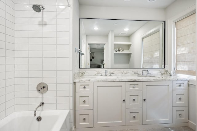 full bath featuring double vanity and bathtub / shower combination