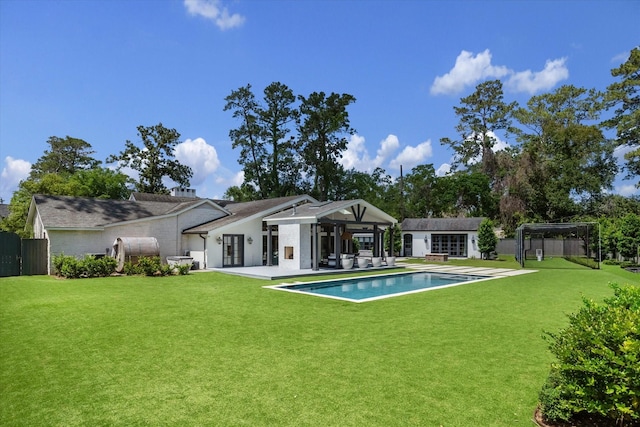 back of property with an outbuilding, an exterior structure, and a patio area