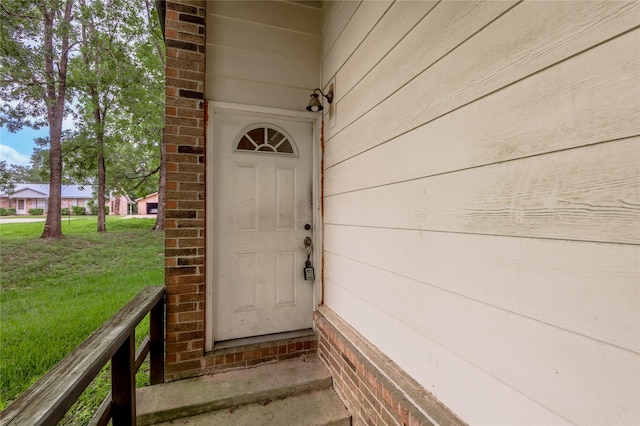 2240 Easley Cir, Huntsville, TX 77320 - view of exterior entry with a yard