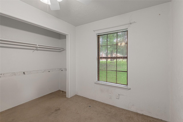 2240 Easley Cir, Huntsville, TX 77320 - unfurnished bedroom featuring light carpet, ceiling fan, and a closet