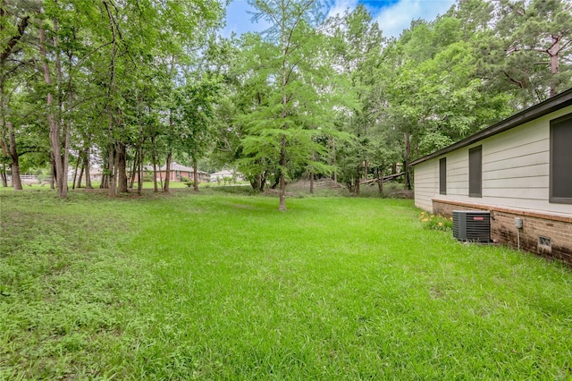 2240 Easley Cir, Huntsville, TX 77320 - view of grassy yard featuring central AC unit