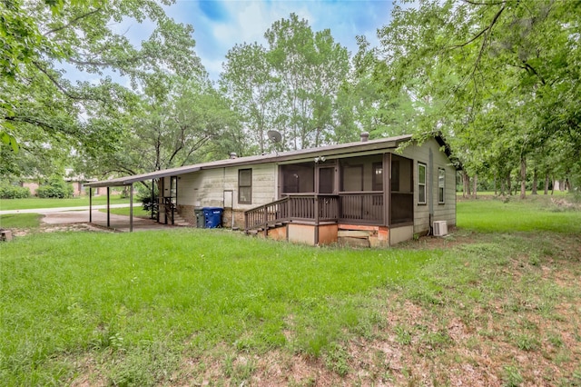 2240 Easley Cir, Huntsville, TX 77320 - rear view of house featuring a sunroom and a lawn