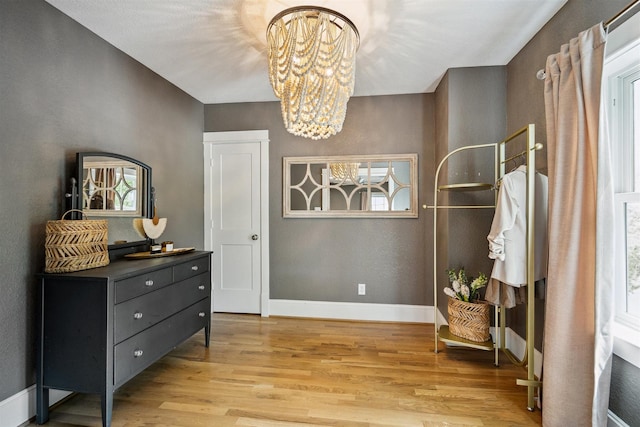412 Merrill St, Houston, TX 77009 - sitting room with a chandelier, light wood-style floors, and baseboards