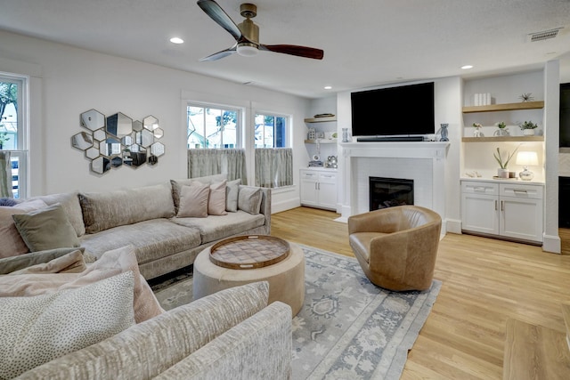 412 Merrill St, Houston, TX 77009 - living room with a fireplace, ceiling fan, light wood-style floors, and recessed lighting