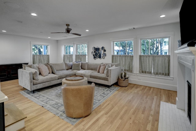 412 Merrill St, Houston, TX 77009 - living room featuring a fireplace with flush hearth, wood finished floors, ceiling fan, and recessed lighting